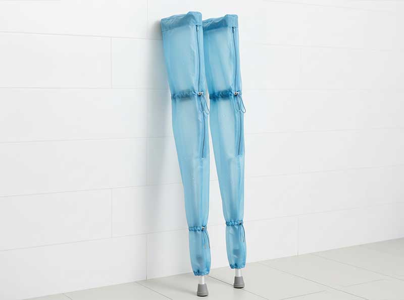 Full-length waterproof crutch covers protecting entire crutches from snow, sleet and winter precipitation
