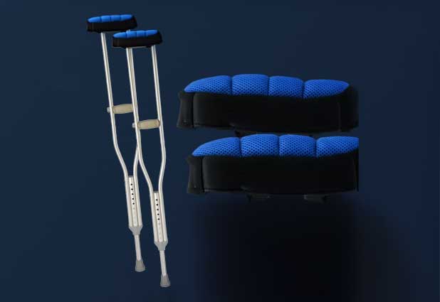 Crutches with padded cushions resting on a bedside table