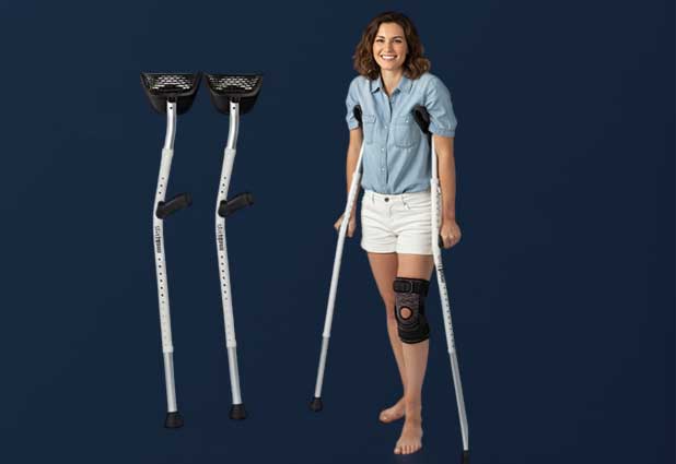 Mobilegs forearm crutches in use inside a living room, showing ergonomic cuff support